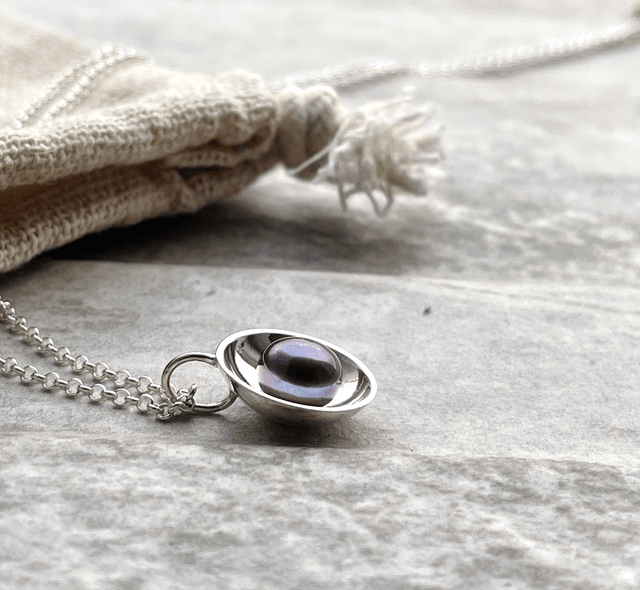 Peacock Pearl in a Silver Dome 